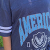 model wearing Land of the Free Jersey Tee